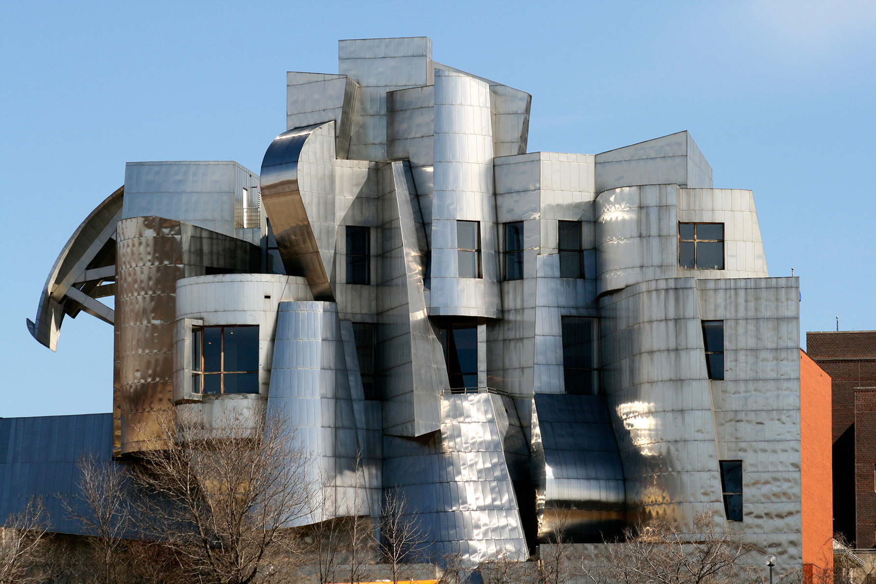 View of the abstract design of the end of the building, covered in brushed metal.