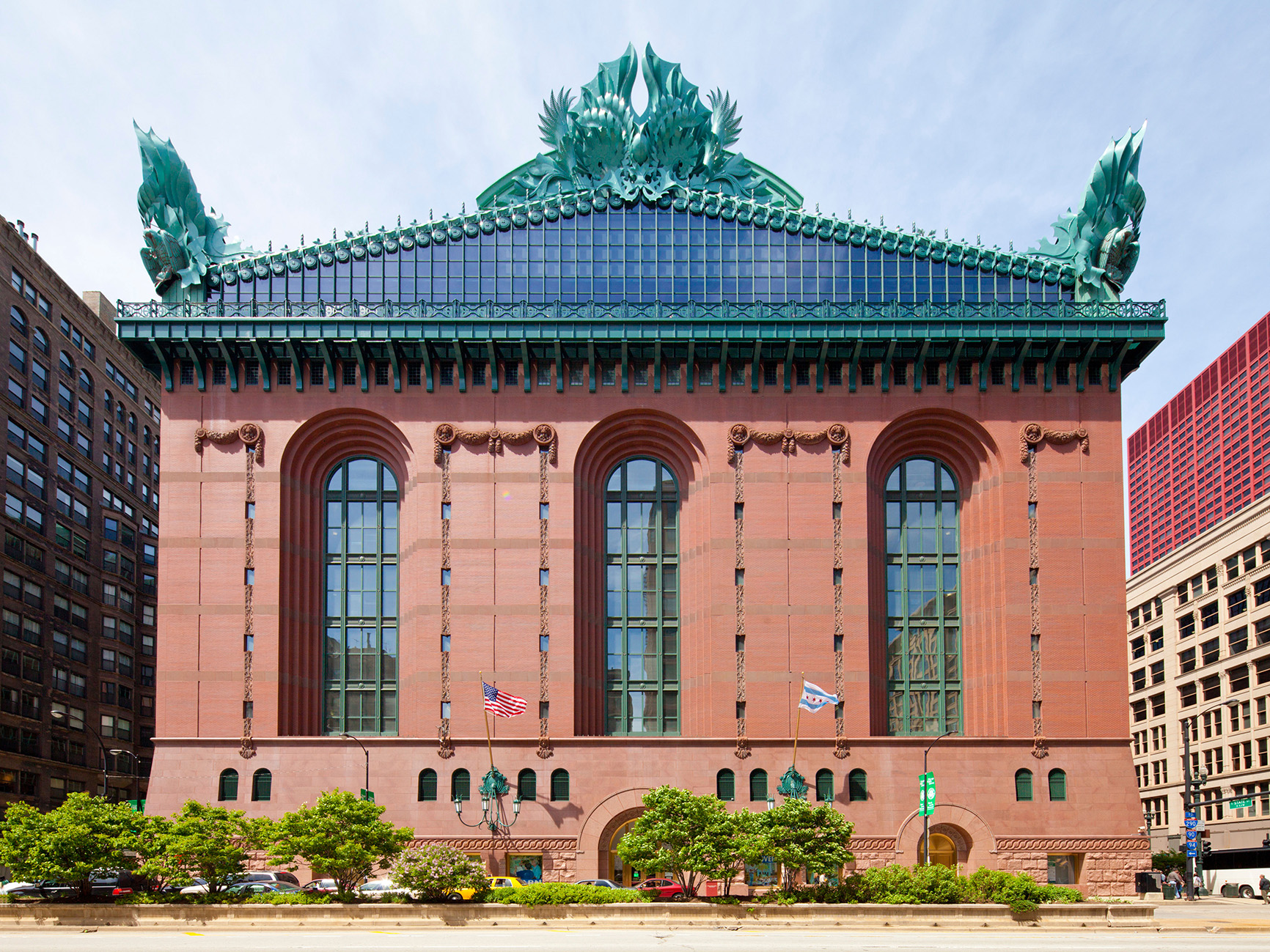 Red brick façade larged arched windows and hightly ornamental glass, steel and aluminium gables.